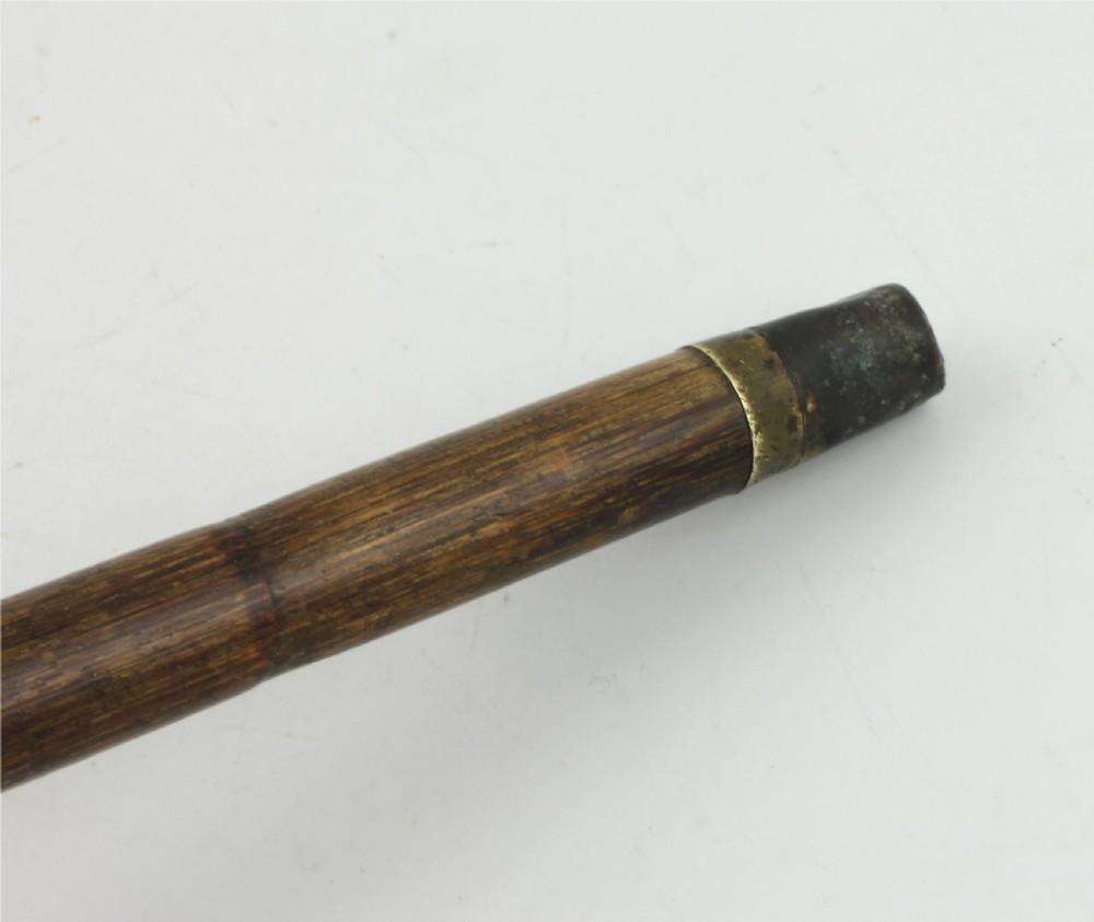 An Edwardian walking stick featuring a curved brown horn handle with a silver tip and an engraved sterling silver collar attached to a dark bamboo shaft. View XIII