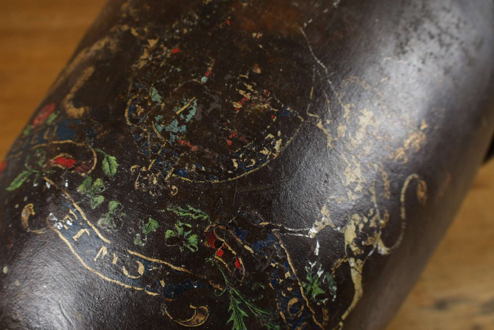 A dark brown Georgian leather fire bucket featuring a heavy strap handle, brass studs around the base, and a painted royal coat of arms with a lion and unicorn. View VIII