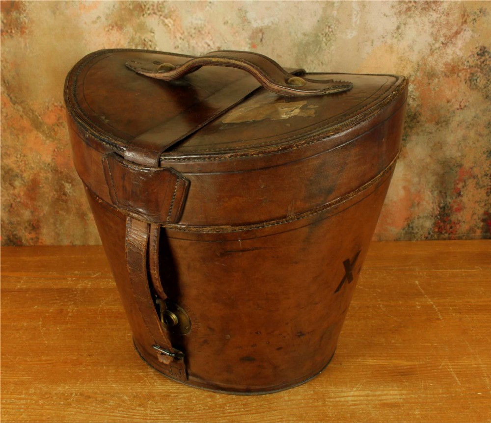 An open Victorian brown leather hat case featuring a padded bright red quilted silk lining and removable hat support collars. View IV