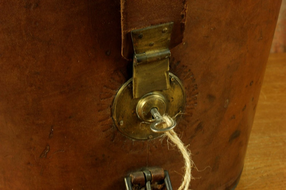 An open Victorian brown leather hat case featuring a padded bright red quilted silk lining and removable hat support collars. View VII