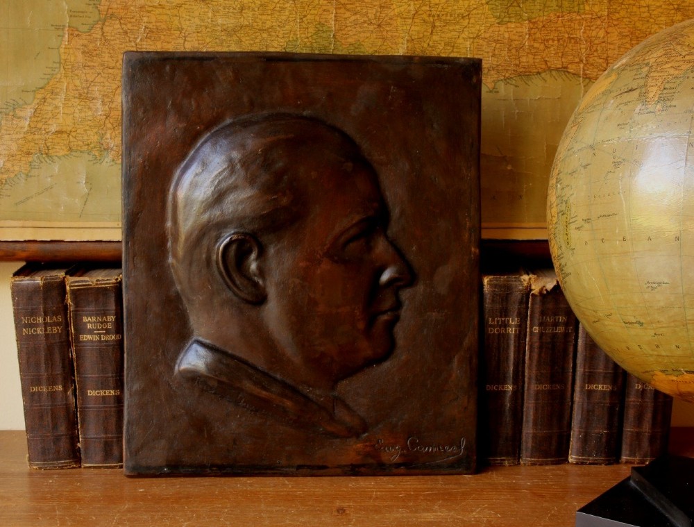 A dark brown bronze rectangular plaque featuring a low-relief profile portrait of a man facing right. View II
