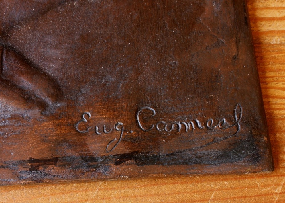 A dark brown bronze rectangular plaque featuring a low-relief profile portrait of a man facing right. View III