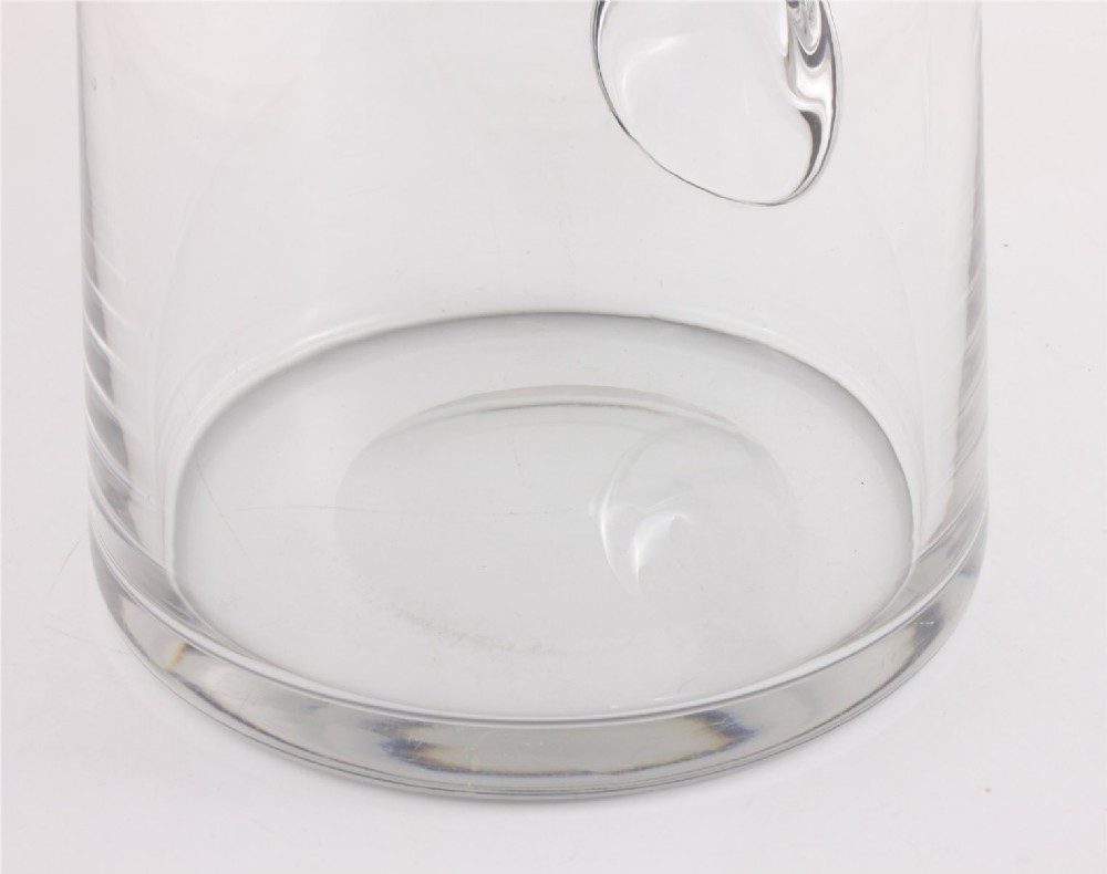 A clear glass water jug with a silver-plated hinged lid, integrated strainer spout, and curved glass handle. View XII