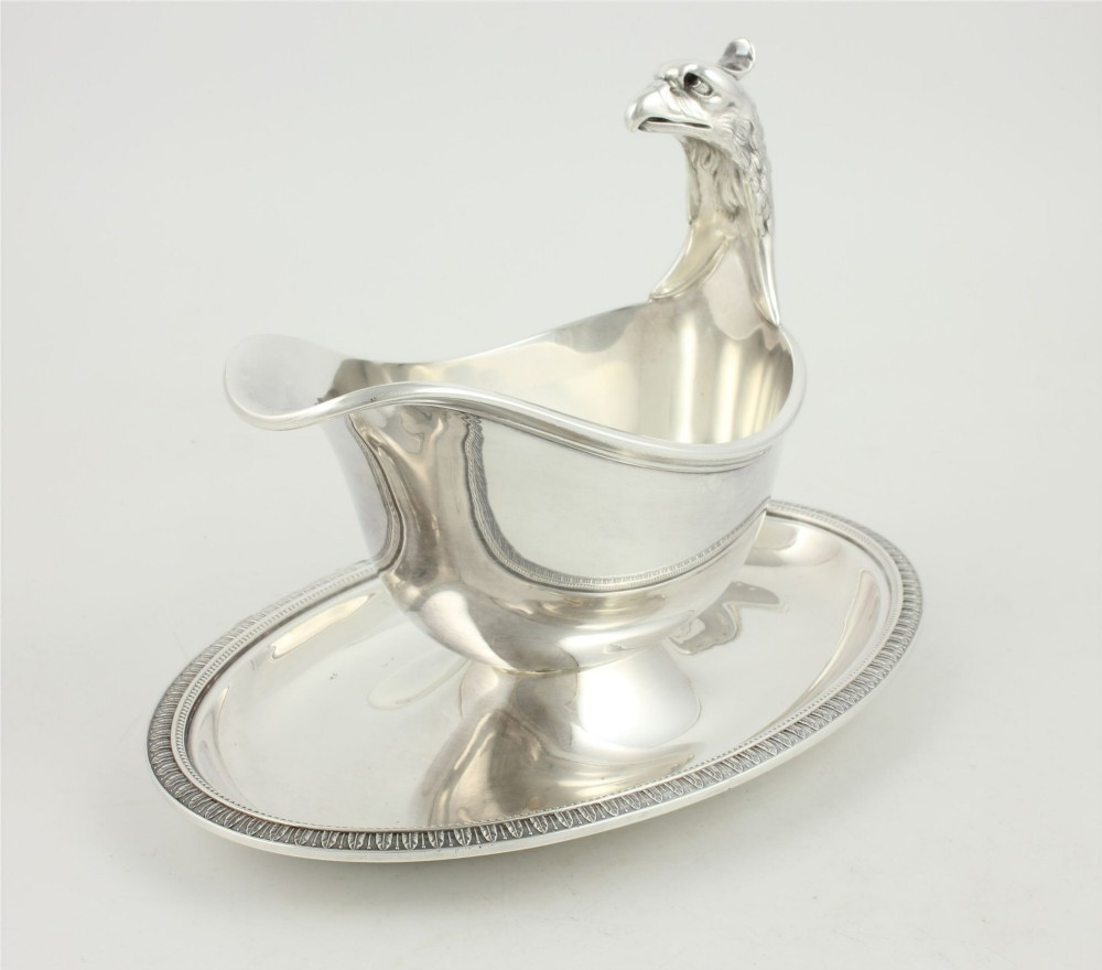 A silver-plated sauce boat featuring a sculpted eagle head handle set upon an integrated oval underplate. View III