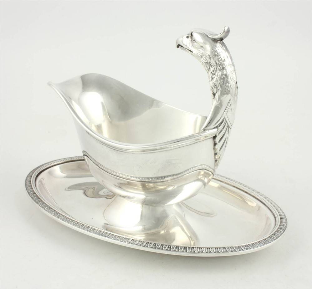 A silver-plated sauce boat featuring a sculpted eagle head handle set upon an integrated oval underplate. View IV