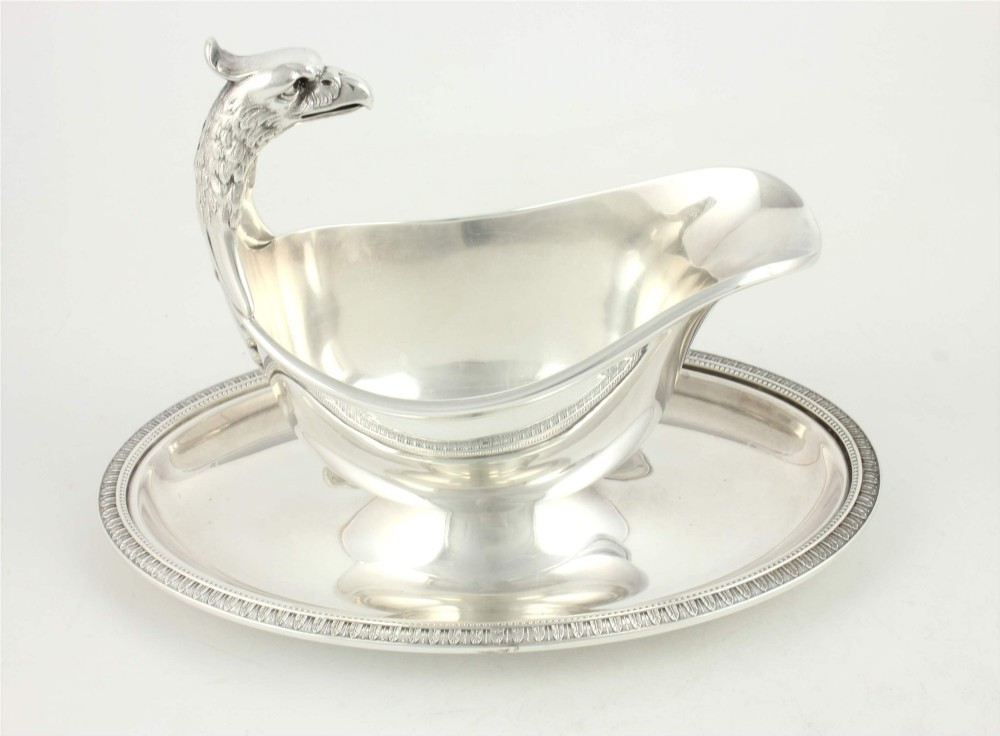 A silver-plated sauce boat featuring a sculpted eagle head handle set upon an integrated oval underplate. View VI
