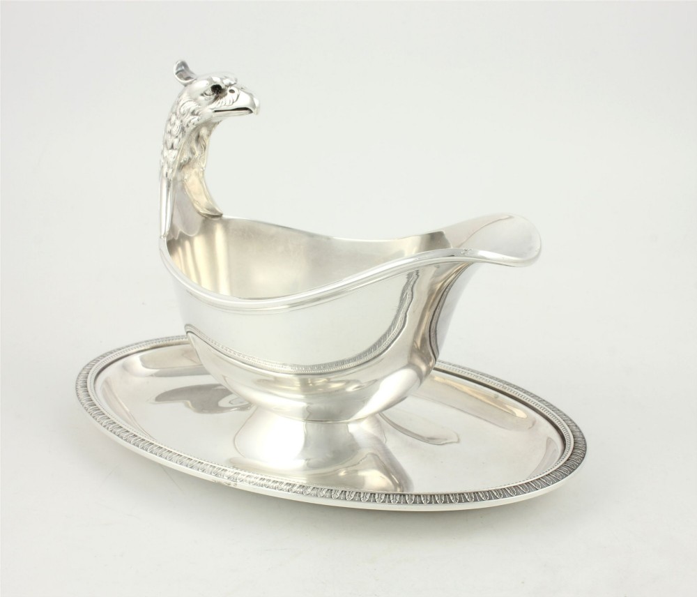 A silver-plated sauce boat featuring a sculpted eagle head handle set upon an integrated oval underplate. View VIII