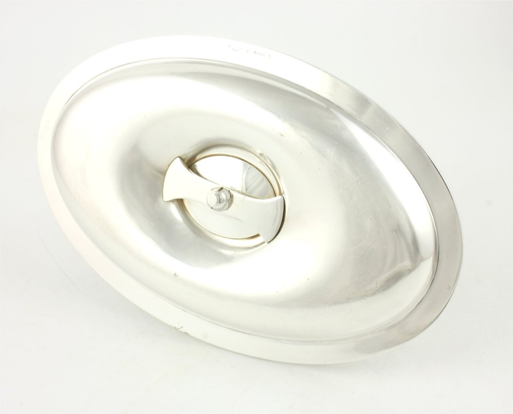 A silver-plated sauce boat featuring a sculpted eagle head handle set upon an integrated oval underplate. View IX