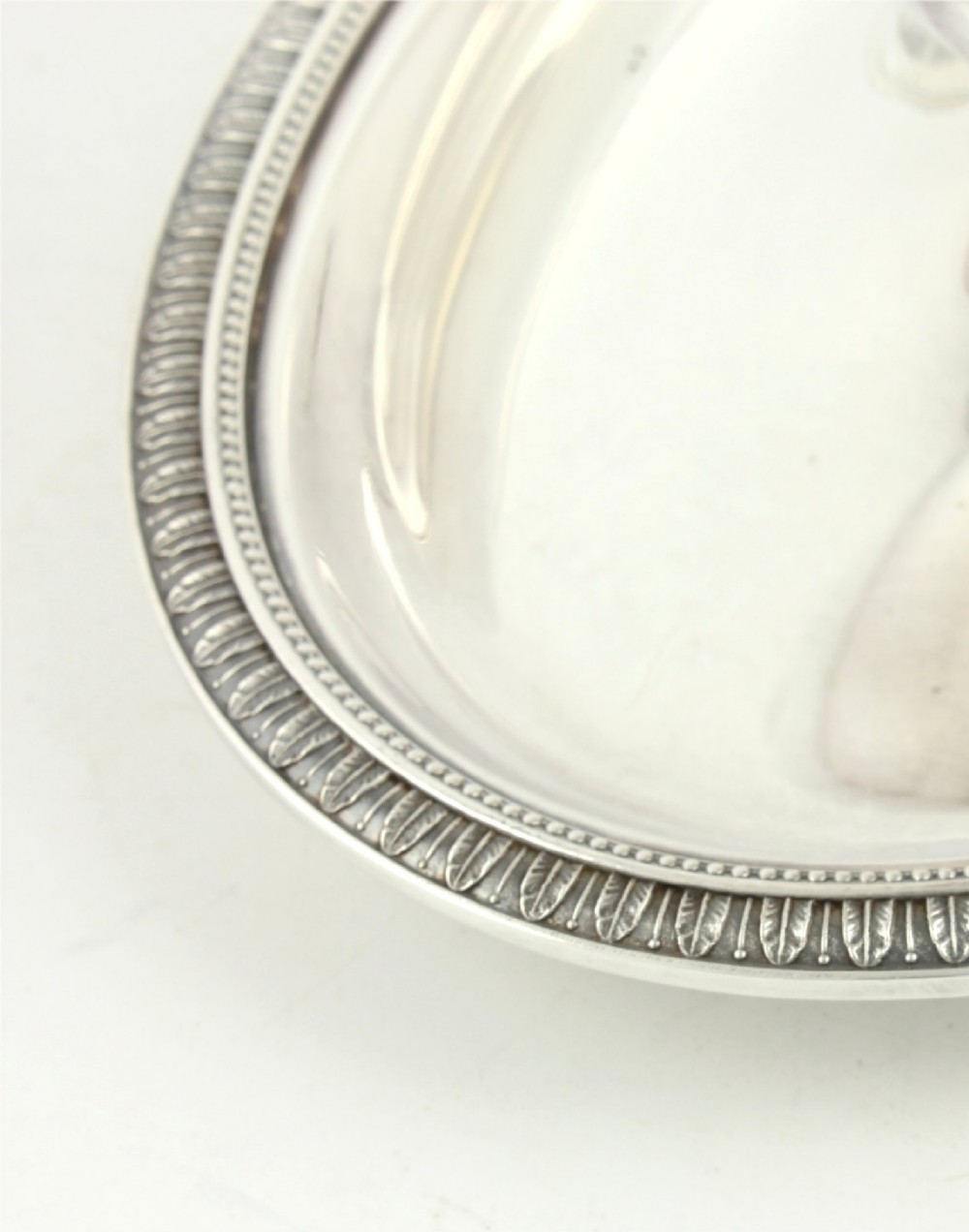 A silver-plated sauce boat featuring a sculpted eagle head handle set upon an integrated oval underplate. View X
