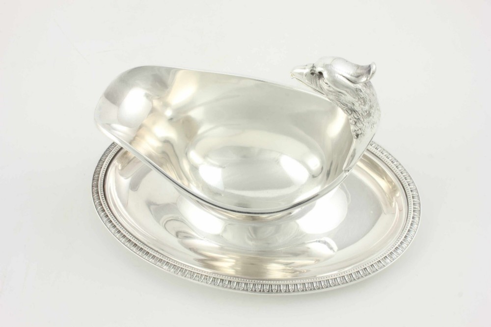 A silver-plated sauce boat featuring a sculpted eagle head handle set upon an integrated oval underplate. View XI