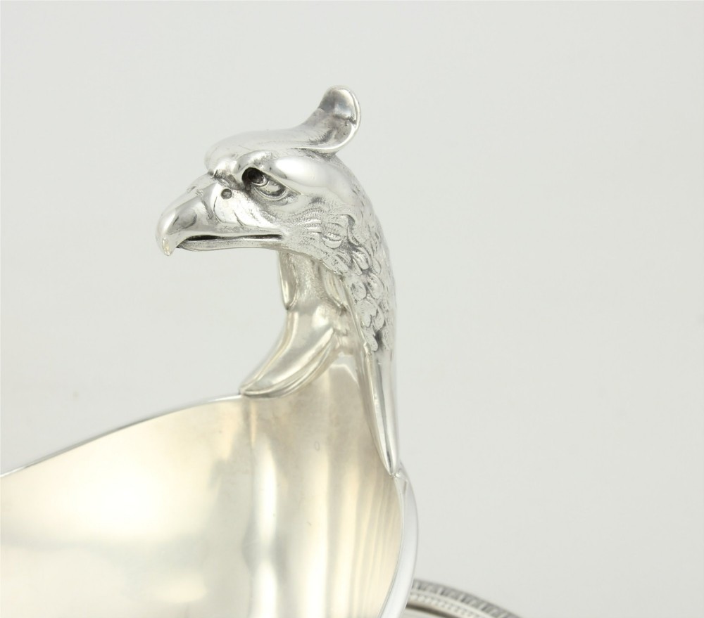 A silver-plated sauce boat featuring a sculpted eagle head handle set upon an integrated oval underplate. View XII