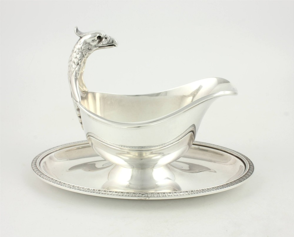 A silver-plated sauce boat featuring a sculpted eagle head handle set upon an integrated oval underplate. View XIII