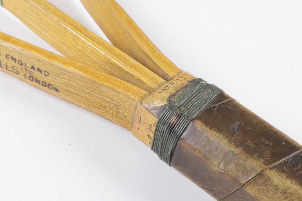 A 1930s Hazells Streamline wooden tennis racket with a triple shaft throat shown alongside a square wooden racket press. View X