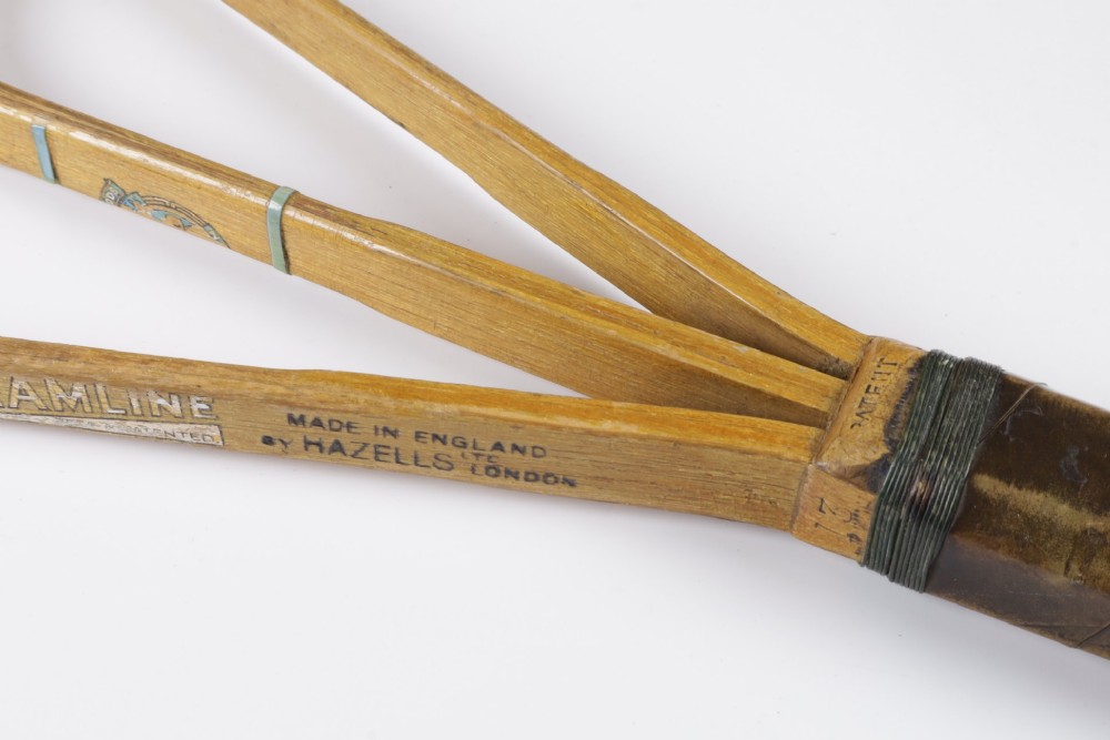 A 1930s Hazells Streamline wooden tennis racket with a triple shaft throat shown alongside a square wooden racket press. View XII