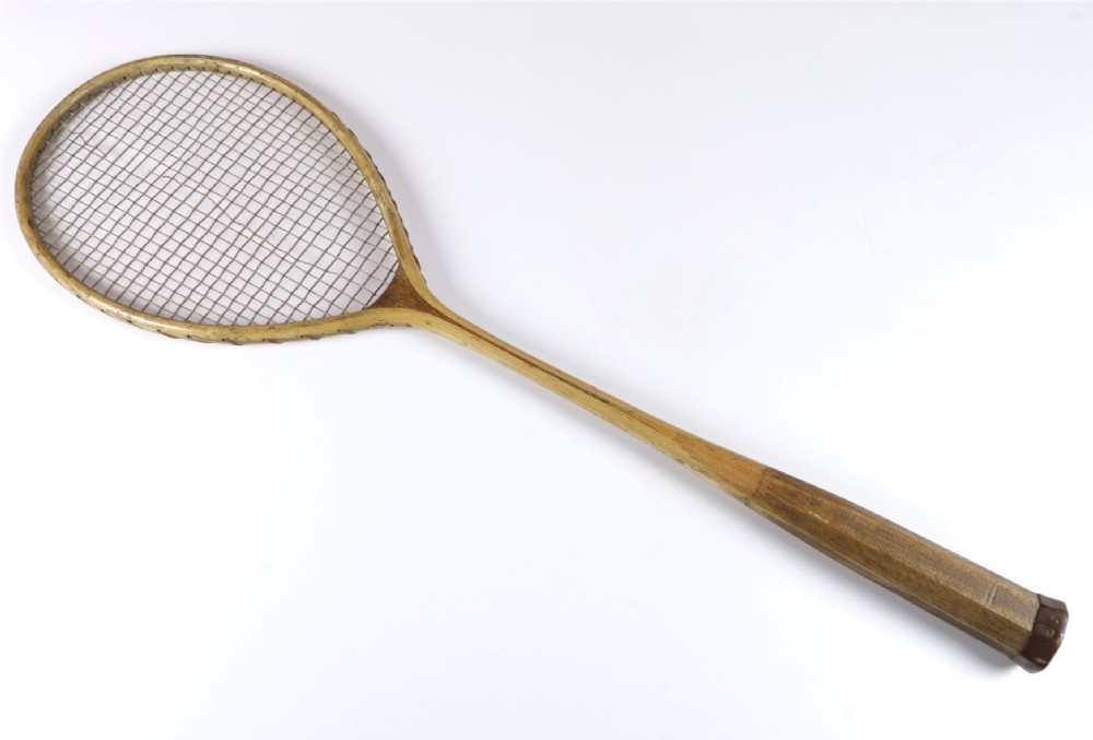 An antique Slazenger wooden badminton racket with a steam-bent frame, stringing, and a long wooden shaft. View III
