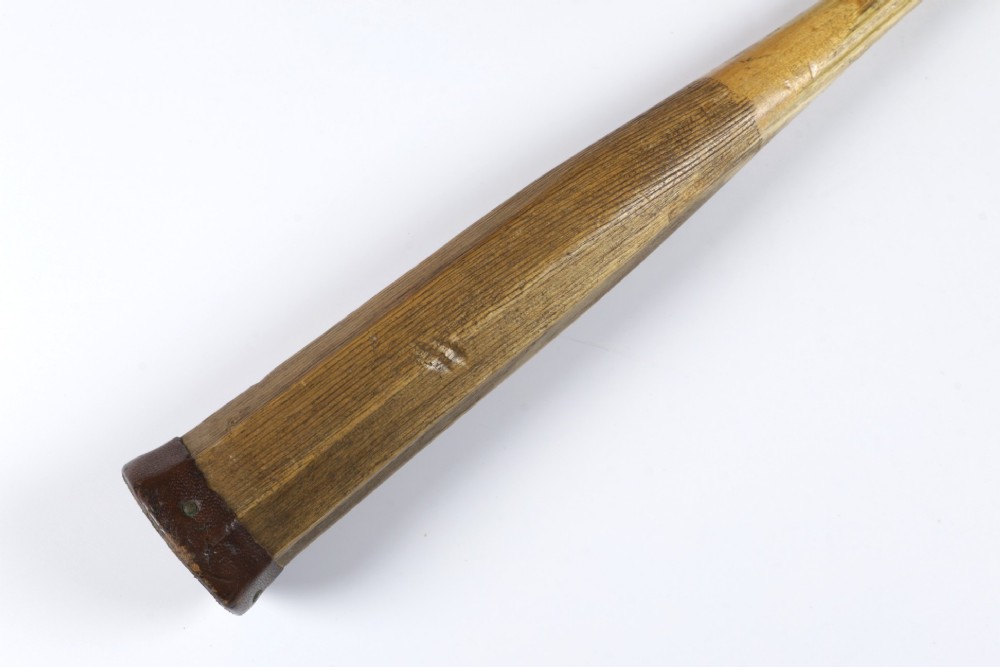An antique Slazenger wooden badminton racket with a steam-bent frame, stringing, and a long wooden shaft. View VII