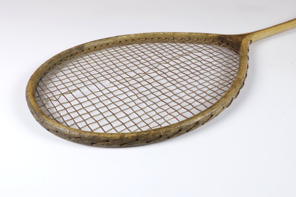 An antique Slazenger wooden badminton racket with a steam-bent frame, stringing, and a long wooden shaft. View X