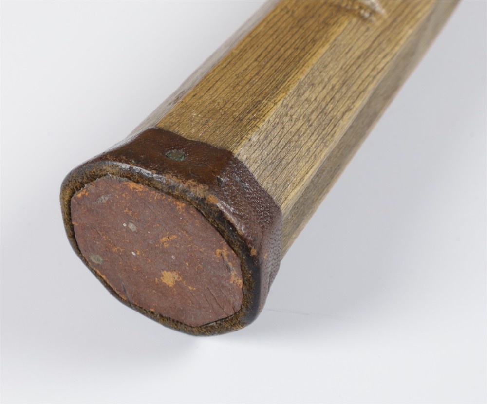 An antique Slazenger wooden badminton racket with a steam-bent frame, stringing, and a long wooden shaft. View XI