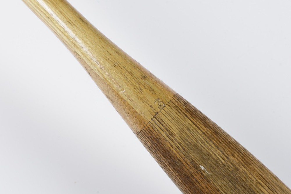 An antique Slazenger wooden badminton racket with a steam-bent frame, stringing, and a long wooden shaft. View XII
