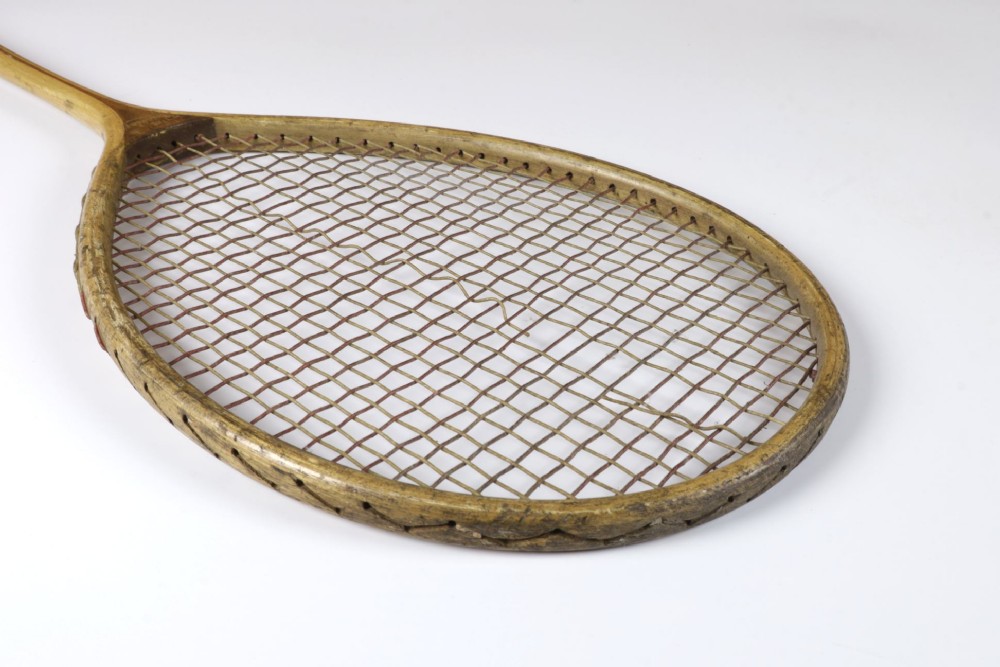 An antique Slazenger wooden badminton racket with a steam-bent frame, stringing, and a long wooden shaft. View XIII