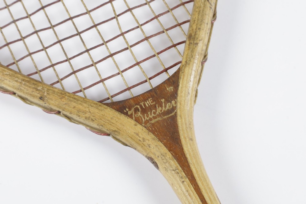 An antique Slazenger wooden badminton racket with a steam-bent frame, stringing, and a long wooden shaft. View XIV
