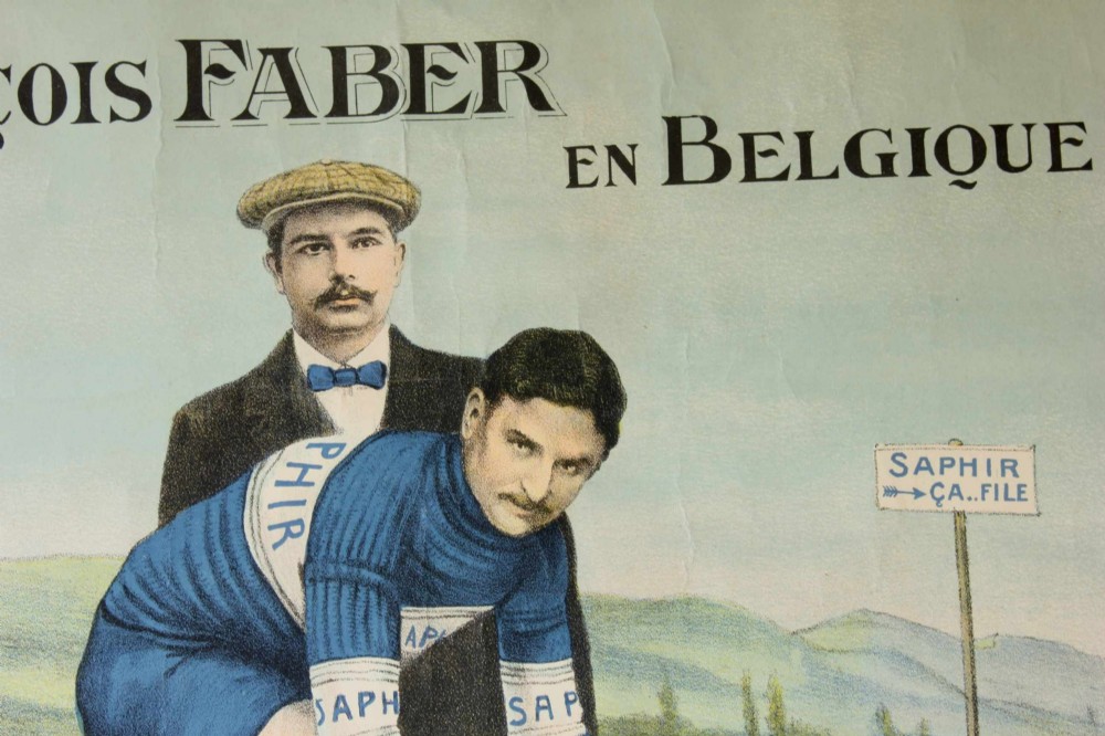 An early twentieth-century Belgian advertising poster depicting cyclist Francois Faber aboard a blue bicycle with French text and a landscape background. View II