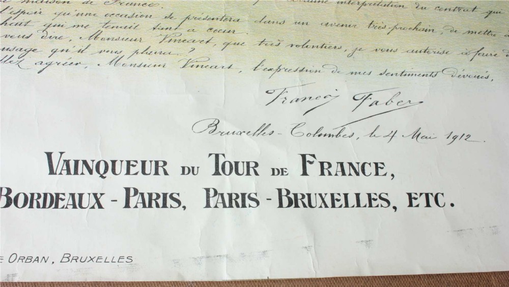 An early twentieth-century Belgian advertising poster depicting cyclist Francois Faber aboard a blue bicycle with French text and a landscape background. View VI