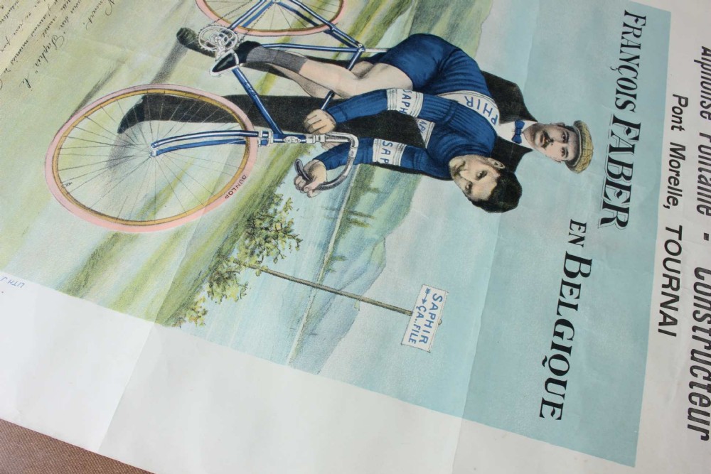 An early twentieth-century Belgian advertising poster depicting cyclist Francois Faber aboard a blue bicycle with French text and a landscape background. View IX