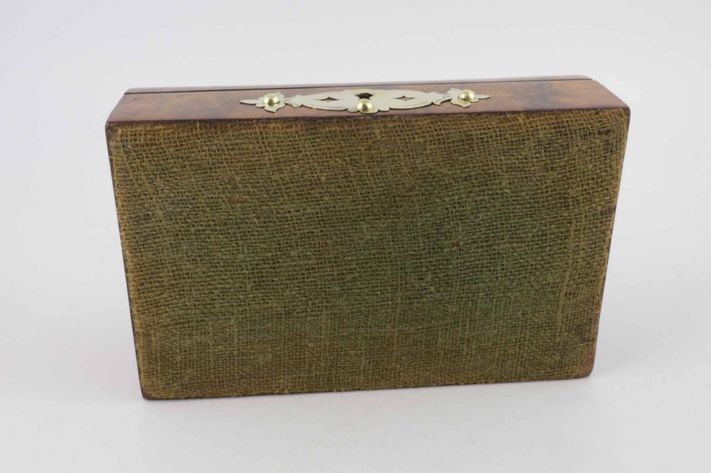 A domed burr walnut box featuring polished brass strapwork depicting three playing cards on the lid and a brass keyhole escutcheon on the front. View XI