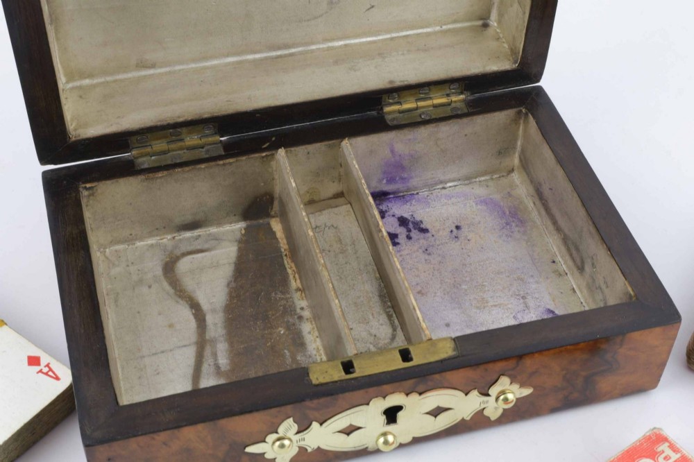 A domed burr walnut box featuring polished brass strapwork depicting three playing cards on the lid and a brass keyhole escutcheon on the front. View XIII