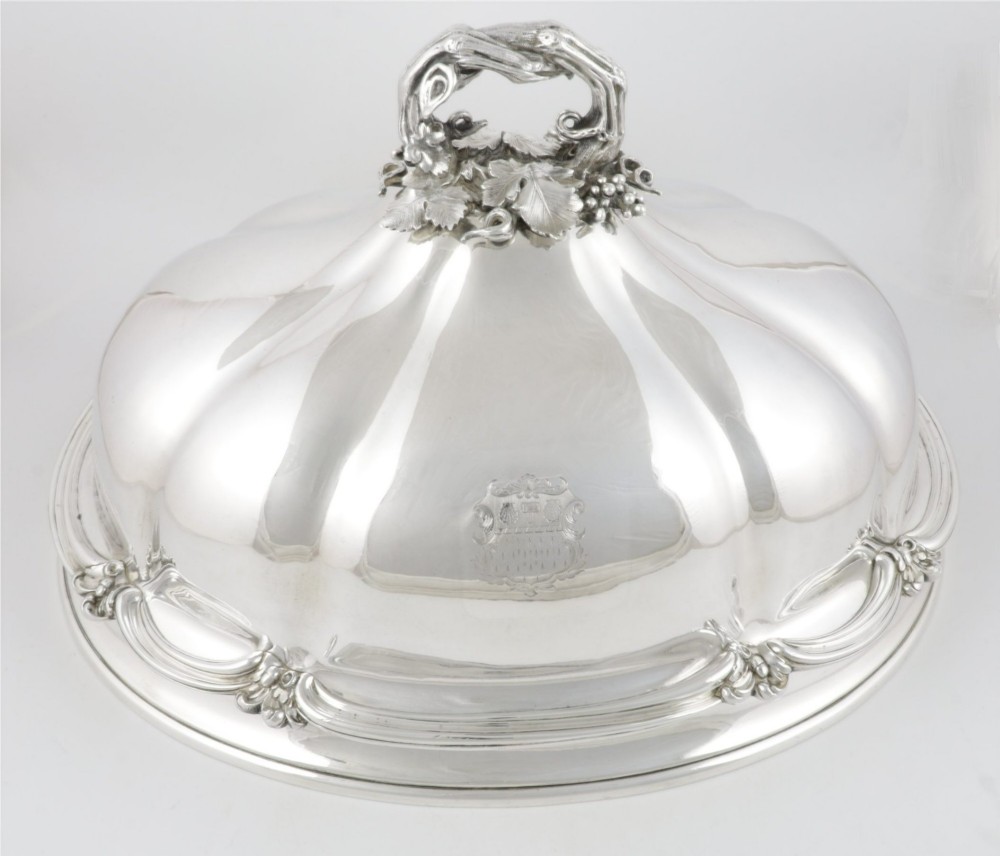 A Georgian Old Sheffield plate silver meat dome featuring a fluted body, an engraved heraldic coat of arms, and a cast handle adorned with vine leaves and grapes. View III