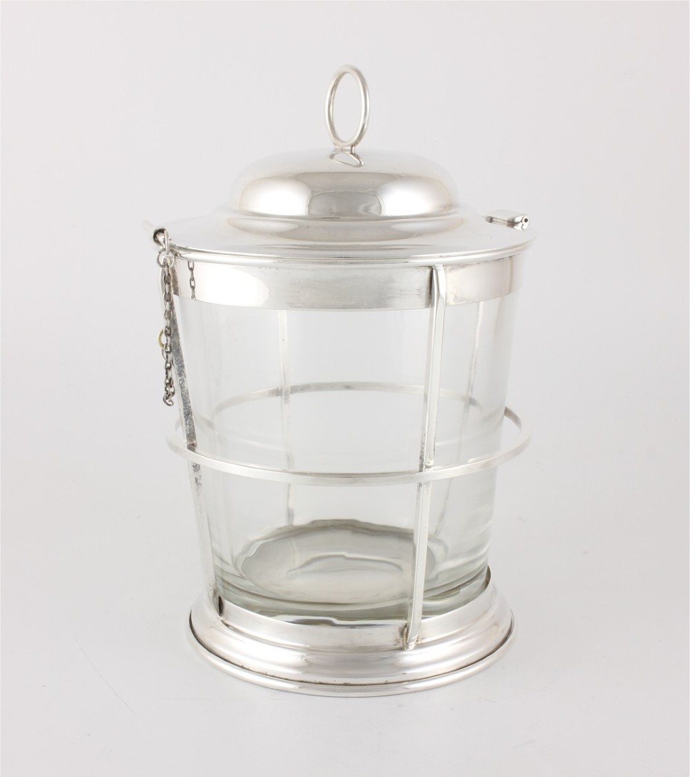 A silver-plated and clear glass ice bucket designed in the form of a nautical ships lantern with a removable lid and chain detail. View V