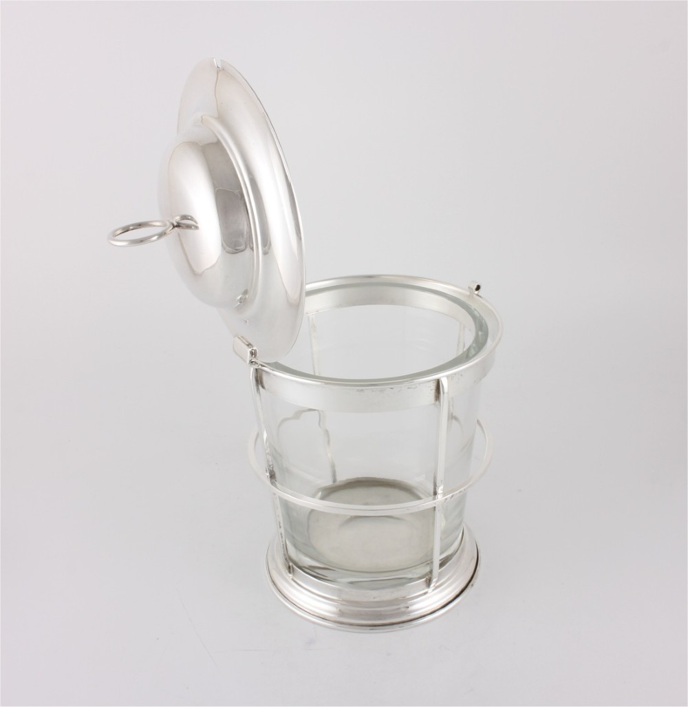 A silver-plated and clear glass ice bucket designed in the form of a nautical ships lantern with a removable lid and chain detail. View VIII