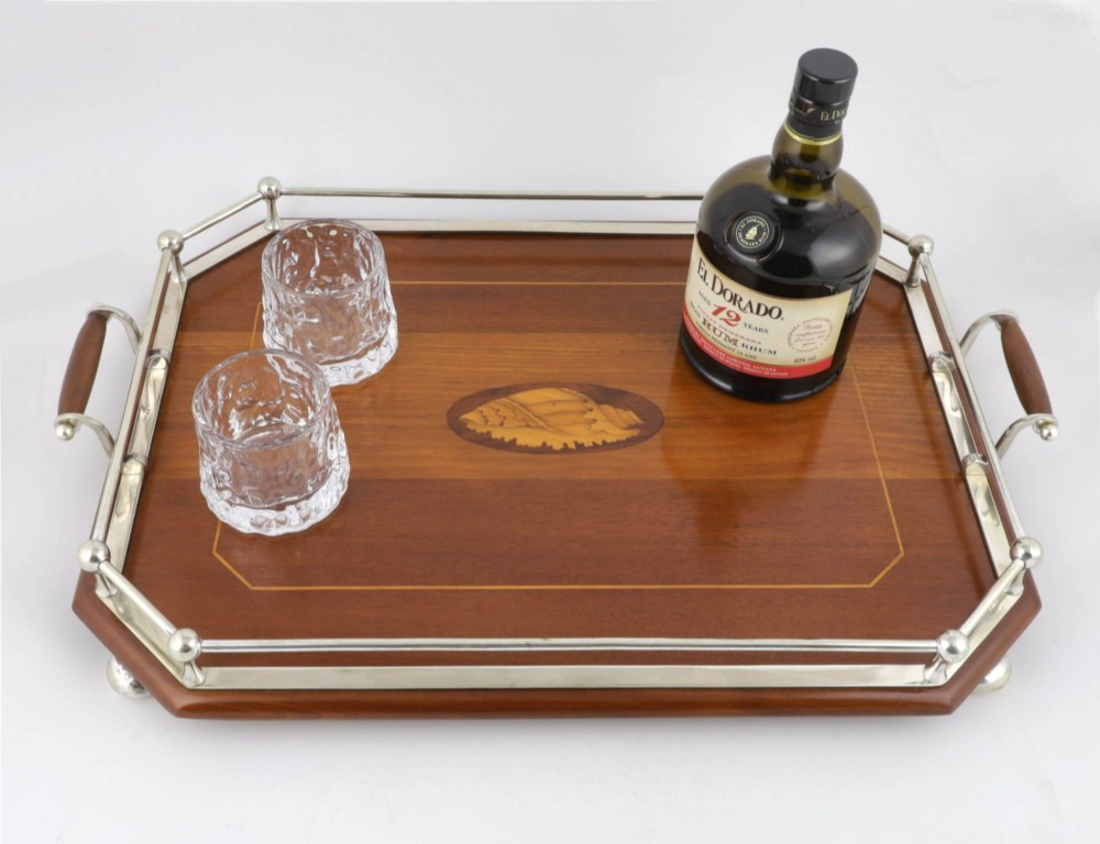 An octagonal brown wooden serving tray featuring a shell marquetry inlay and a polished silver-plated gallery rail. View II