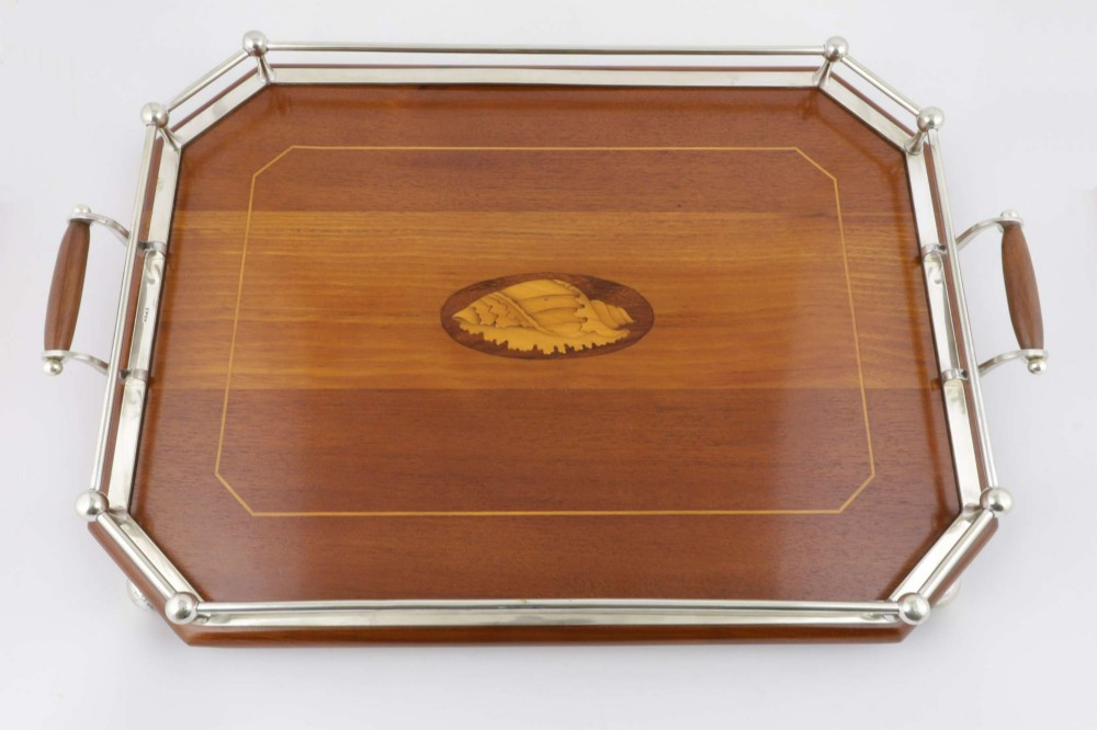 An octagonal brown wooden serving tray featuring a shell marquetry inlay and a polished silver-plated gallery rail. View III
