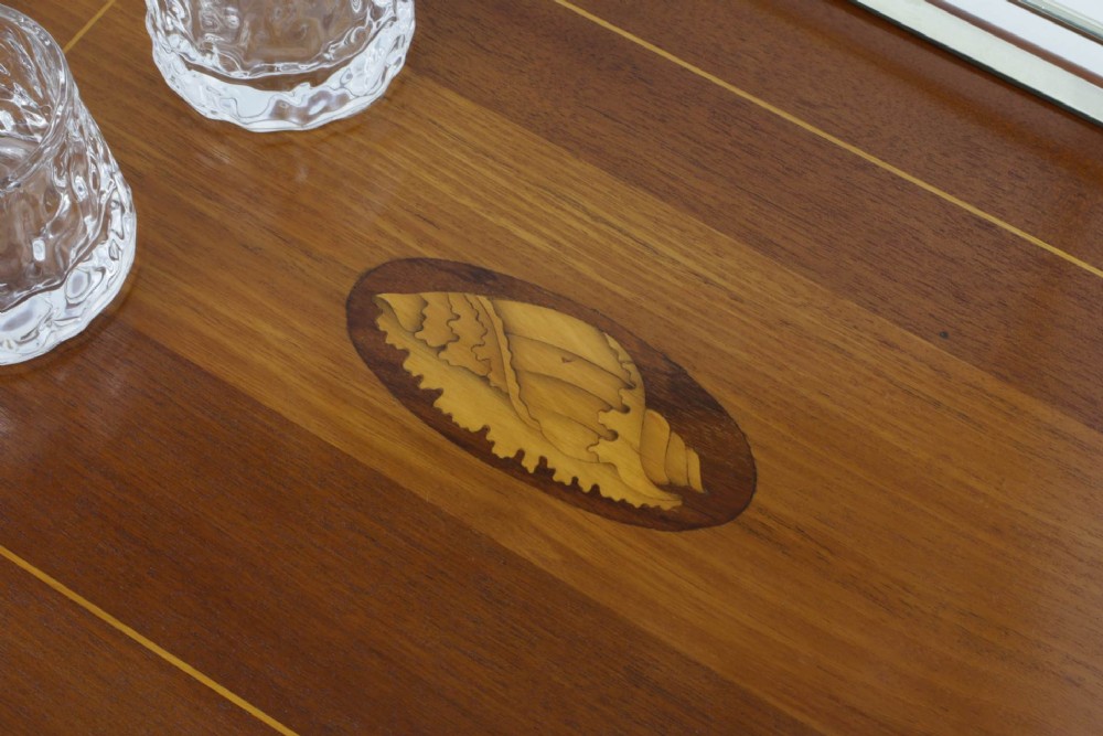 An octagonal brown wooden serving tray featuring a shell marquetry inlay and a polished silver-plated gallery rail. View V