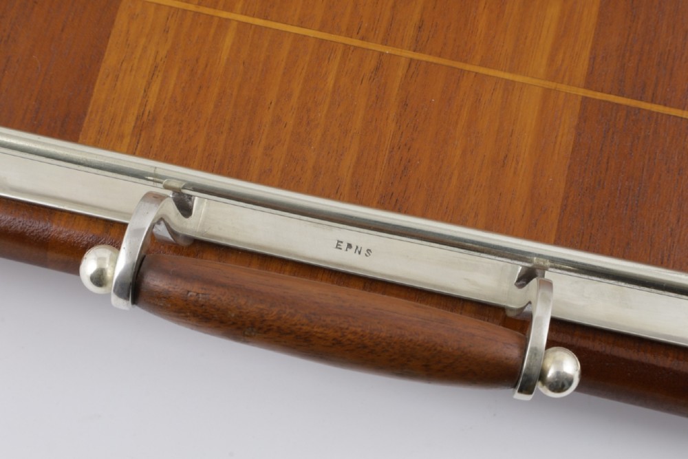 An octagonal brown wooden serving tray featuring a shell marquetry inlay and a polished silver-plated gallery rail. View VIII