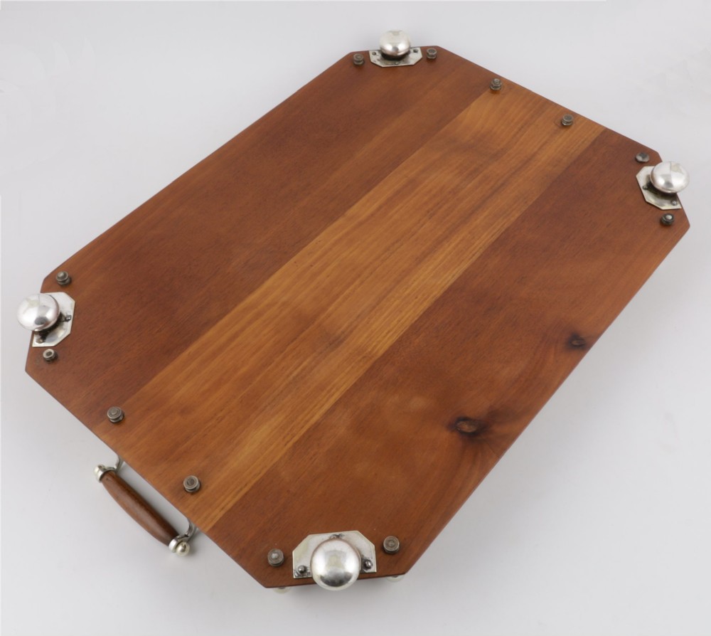 An octagonal brown wooden serving tray featuring a shell marquetry inlay and a polished silver-plated gallery rail. View XIII