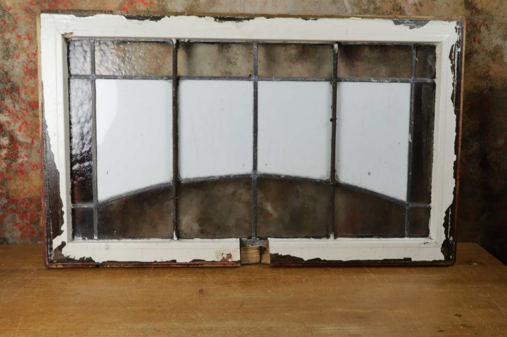 An Edwardian leaded glass window panel set in a dark wooden frame with white glass panes featuring black lettering that reads DENTAL SURGEON. View VIII