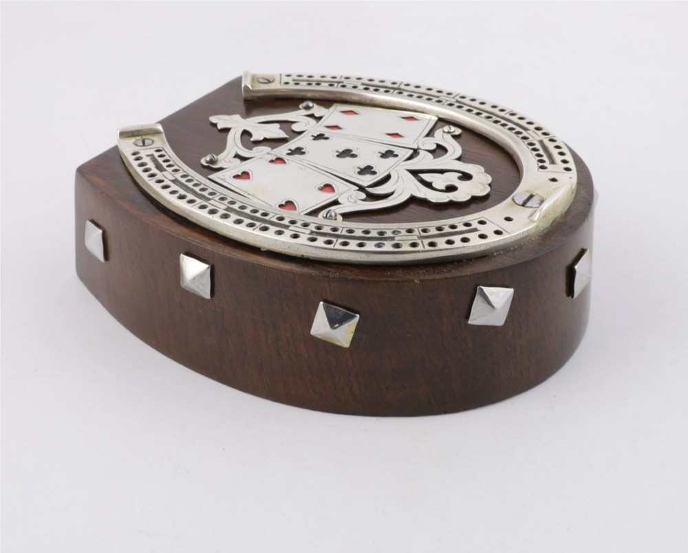 An antique horseshoe-shaped dark oak games box featuring silver metal scrollwork, playing card motifs, and an integrated cribbage scoring track. View VIII