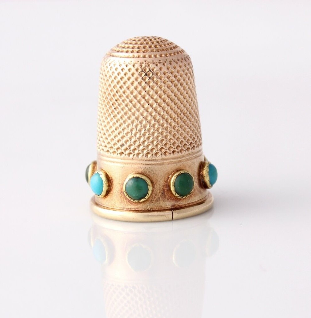 An antique Victorian 15ct gold thimble with turquoise cabochon studs displayed inside an open red leather velvet-lined case. View IV