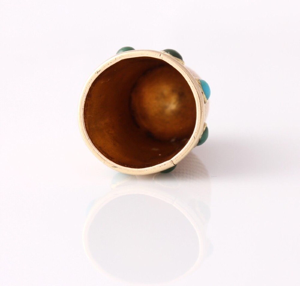 An antique Victorian 15ct gold thimble with turquoise cabochon studs displayed inside an open red leather velvet-lined case. View X