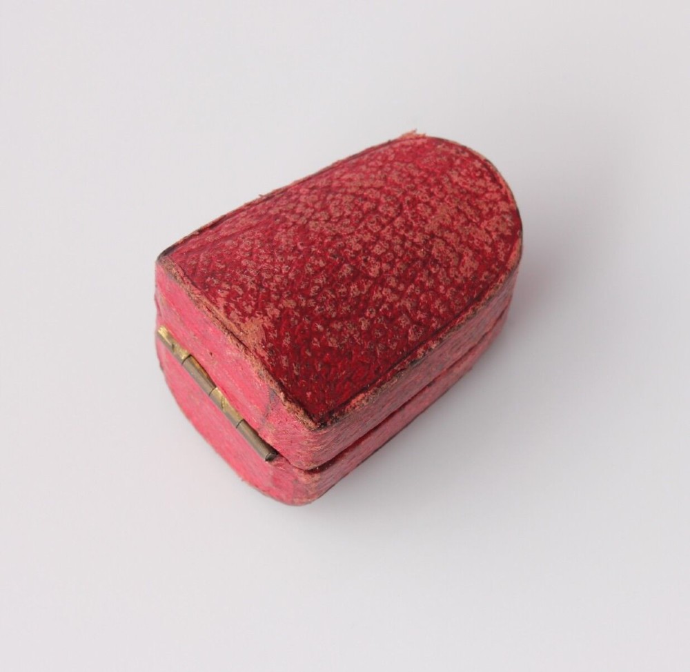An antique Victorian 15ct gold thimble with turquoise cabochon studs displayed inside an open red leather velvet-lined case. View XII