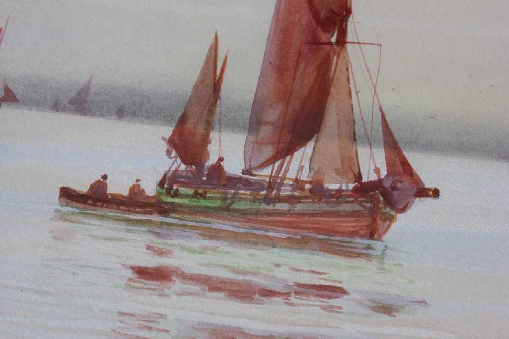 A framed early twentieth-century watercolour painting featuring red-sailed fishing boats on calm waters off Scarborough, enclosed in a thick black frame with a gold inner slip. View XII