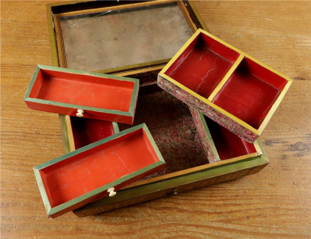A rectangular wooden box top featuring intricate straw marquetry depicting a harbour landscape with ships, fortresses, and geometric borders. View VI