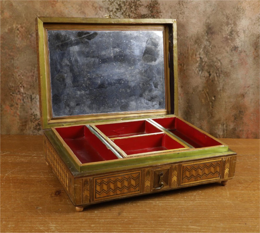A rectangular wooden box top featuring intricate straw marquetry depicting a harbour landscape with ships, fortresses, and geometric borders. View XII