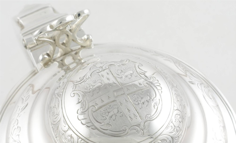 An engraved silver lidded jug featuring a hinged cap, scrolling handle, and foliate engraving across the body. View III