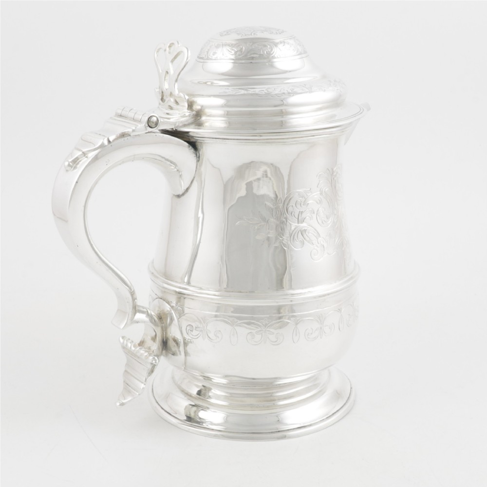 An engraved silver lidded jug featuring a hinged cap, scrolling handle, and foliate engraving across the body. View VIII
