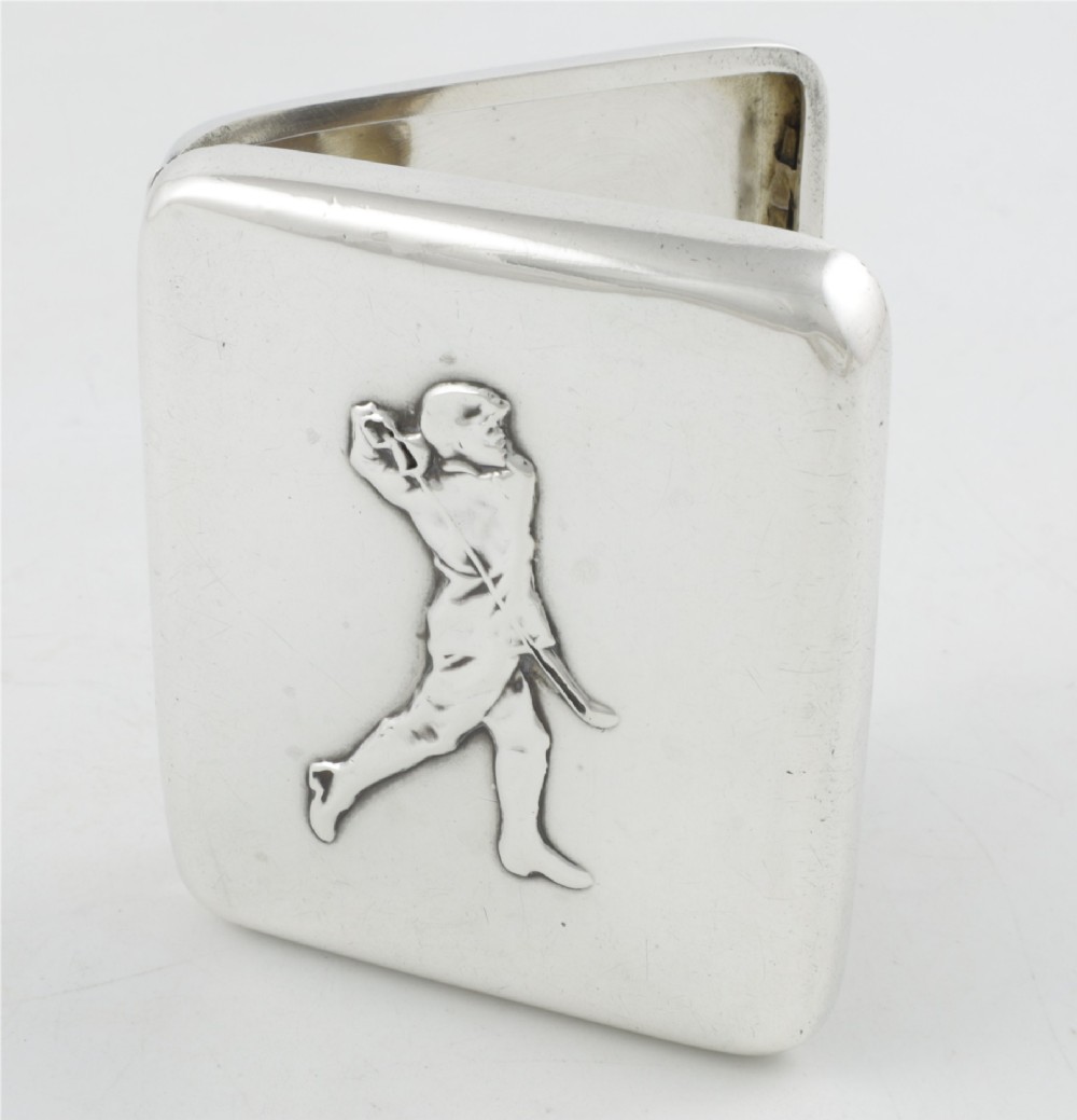 An Edwardian sterling silver cigarette case featuring an embossed relief figure of a golfer in mid-swing on the front cover.