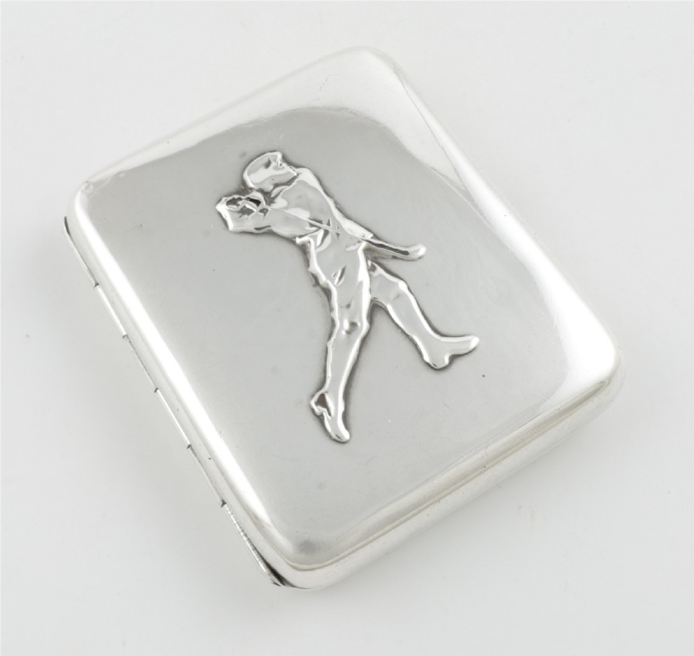 An Edwardian sterling silver cigarette case featuring an embossed relief figure of a golfer in mid-swing on the front cover. View II